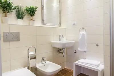 a white bathroom with a sink and a mirror at Central Belgrade Apartments 3 in Belgrade