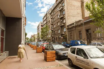 a woman walking down a city street with at Central Belgrade Apartments 3 in Belgrade