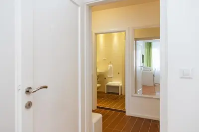 a bathroom with a tub and a toilet and a mirror at Central Belgrade Apartments 3 in Belgrade