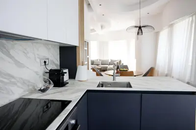 a kitchen with a sink and a living room at Villa Vanja Belgrade in Belgrade
