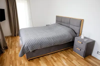 a bedroom with a bed and a nightstand with a bed sidx sidx sidx sidx at Villa Vanja Belgrade in Belgrade