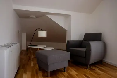 a living room with a chair and a table at Villa Vanja Belgrade in Belgrade