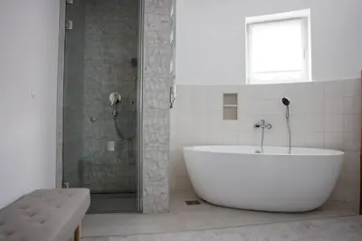 a white bath tub in a bathroom with a shower at Villa Vanja Belgrade in Belgrade