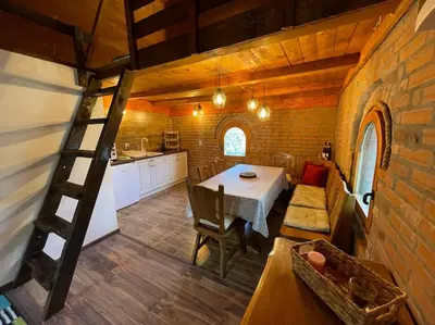 a kitchen and dining room with a table and a ladder at River House in Belgrade