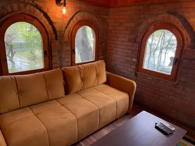 a living room with a couch in a brick wall at River House in Belgrade