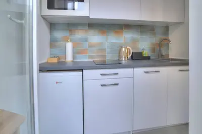 a kitchen with white cabinets and a sink at Dorćol Central Apartment-NEW in Belgrade