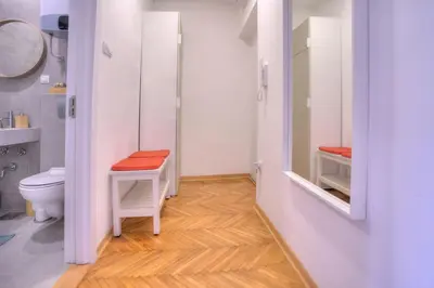 a white bathroom with a toilet and a sink at Dorćol Central Apartment-NEW in Belgrade