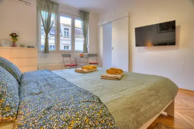 a bedroom with a bed with two towels on it at Dorćol Central Apartment-NEW in Belgrade