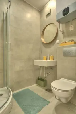 a bathroom with a toilet and a sink and a mirror at Dorćol Central Apartment-NEW in Belgrade