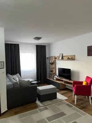 a living room with a couch and a tv at Airport SKY apartments LUX in Belgrade