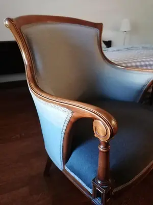 a chair with a blue seat in a bedroom at Kalemegdan centar in Belgrade