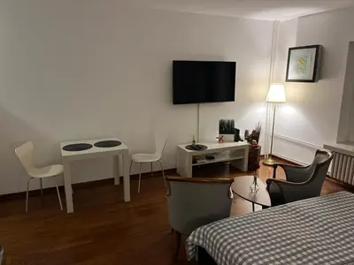 a hotel room with a bed and a table and a tv at Kalemegdan centar in Belgrade