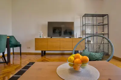 a bowl of oranges on a table in a living room at City View in Dušanovac (historical)