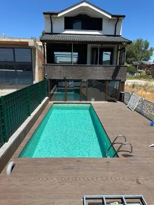 a house with a swimming pool in front of a house at Belgrade River House in Belgrade