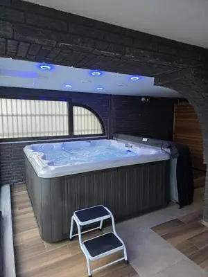 a large hot tub with a stool in a room at Belgrade River House in Belgrade