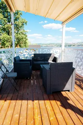 a deck with chairs and tables on a boat at Belgrade River House in Belgrade