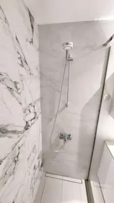 a bathroom with a shower with a glass door at BW Central View - Belgrade Waterfront in Belgrade
