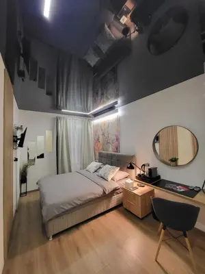 a bedroom with a bed and a mirror and a desk at Luxury Central Square Apartment 2214 in Belgrade