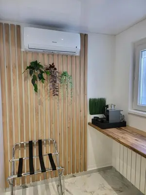 a chair in a room with a wooden wall at Luxury Central Square Apartment 2214 in Belgrade