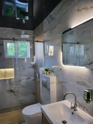 a bathroom with a sink and a toilet and a mirror at Luxury Central Square Apartment 2214 in Belgrade