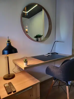 a desk with a chair and a mirror on a wall at Luxury Central Square Apartment 2214 in Belgrade