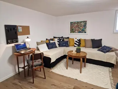 a living room with a couch and a table with a laptop at Apartman Pobednik in Belgrade