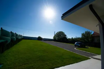 a car parked in the driveway of a house at Vila Julija in Surduk