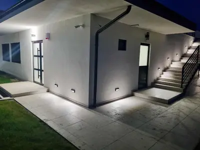 a hallway of a building with stairs and a door at Vila Julija in Surduk