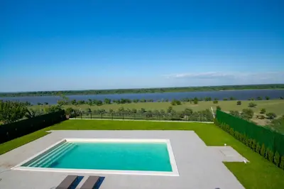 a swimming pool with a view of the water at Vila Julija in Surduk
