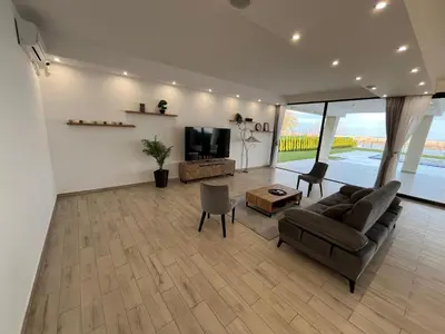 a living room with a couch and a tv at Vila Julija in Surduk