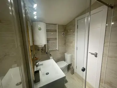 a bathroom with a toilet and a sink and a shower at Apartman Maki in Pančevo