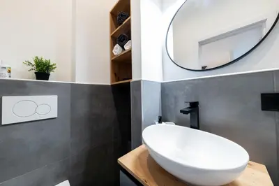 a bathroom with a white sink and a mirror at Belgrade Apartment Nook in Belgrade
