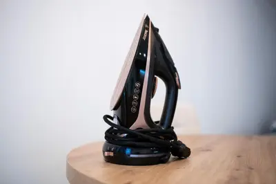 a black iron sitting on top of a wooden table at Belgrade Apartment Nook in Belgrade