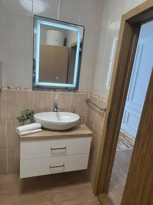 a bathroom with a sink and a mirror at Maja lux in Ruma