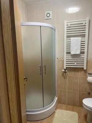 a glass shower in a bathroom with a toilet at Maja lux in Ruma