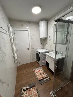 a small bathroom with a sink and a shower at Apartman ARISTEA in Arandjelovac