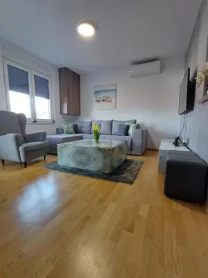 a living room with a couch and a table at Apartman ARISTEA in Arandjelovac