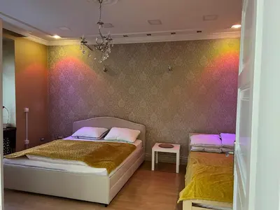 a bedroom with two beds and a colorful wall at Life & Work in Belgrade Centre with FREE parking! in Belgrade