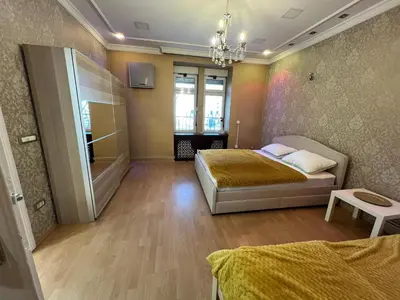 a bedroom with a bed and a chandelier at Life & Work in Belgrade Centre with FREE parking! in Belgrade