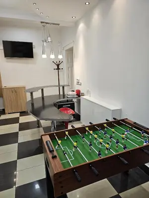 a foosball table in the middle of a living room at Life & Work in Belgrade Centre with FREE parking! in Belgrade
