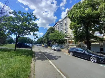 a street with cars parked on the side of the road at Under the Tree in Novi Beograd