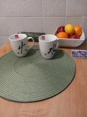 two coffee cups sitting on top of a table at Under the Tree in Novi Beograd