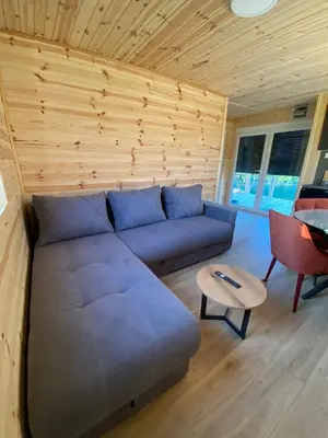 a living room with a couch and a table at Tiny house Neny Fruška gora in Velika Remeta