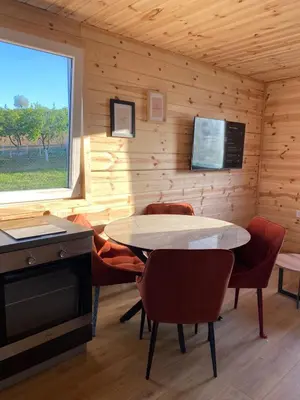 a room with a table and chairs and a window at Tiny house Neny Fruška gora in Velika Remeta