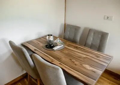 a dining room table with chairs and a wooden table with aasteryasteryasteryastery at Brvnara Staničić in Arandjelovac
