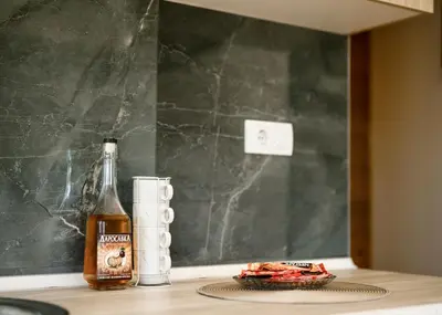 a bottle of beer sitting on a counter next to a glass at Brvnara Staničić in Arandjelovac
