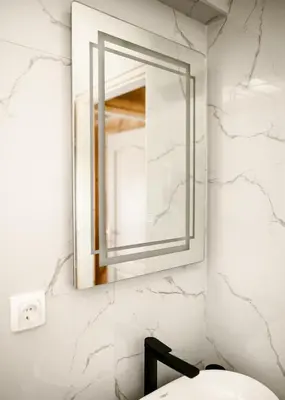 a mirror on a wall above a sink in a bathroom at Brvnara Staničić in Arandjelovac