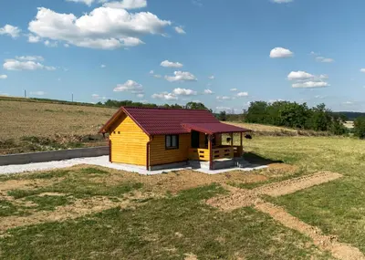 a small cabin in the middle of a field at Brvnara Staničić in Arandjelovac