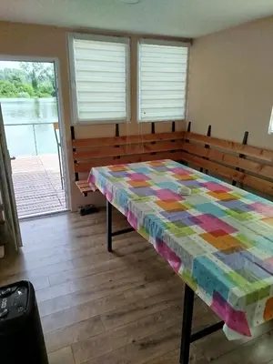 a table with a colorful quilt on it in a room at Splav na dan AXA in Barič