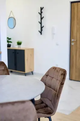 a table and two chairs in a room with a table at Airport Belgrade Apartments in Surčin